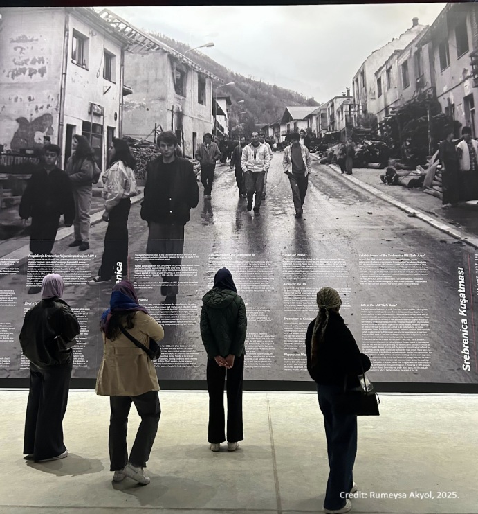 Viewing a historical photo at the Srebrenica Memorial Center.