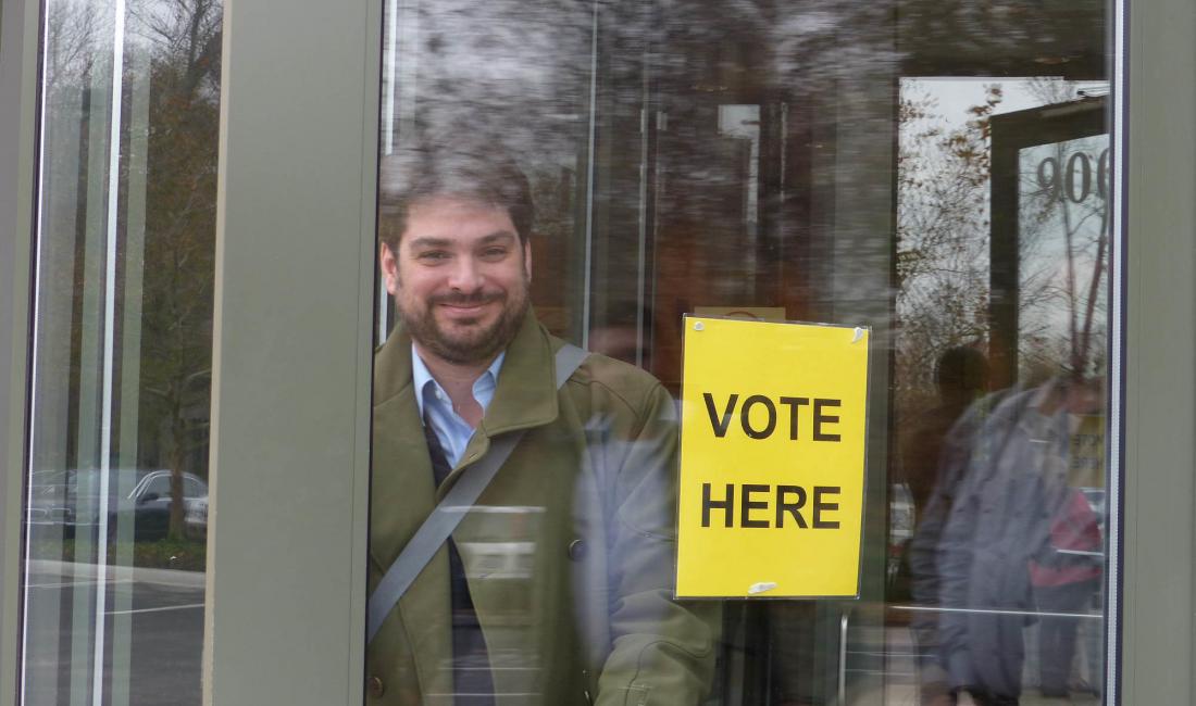 Rafael Pineiro, board member of Democracy International, leaves a polling station in Kansas during the 2014 US midterm elections, with several ballot measures.
