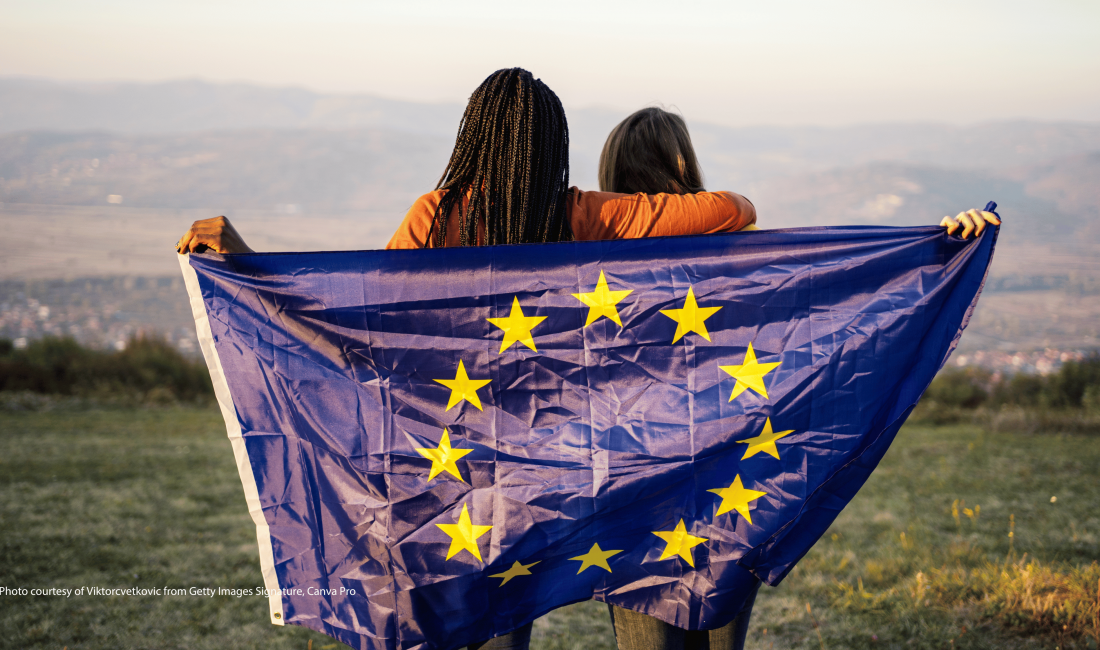 Image of two people holding an EU flag